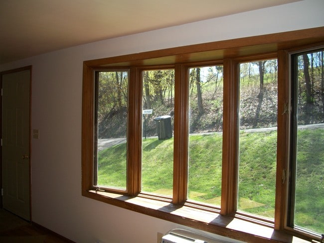 Bay window in living room next to entry door. - 502 Mercer Rd