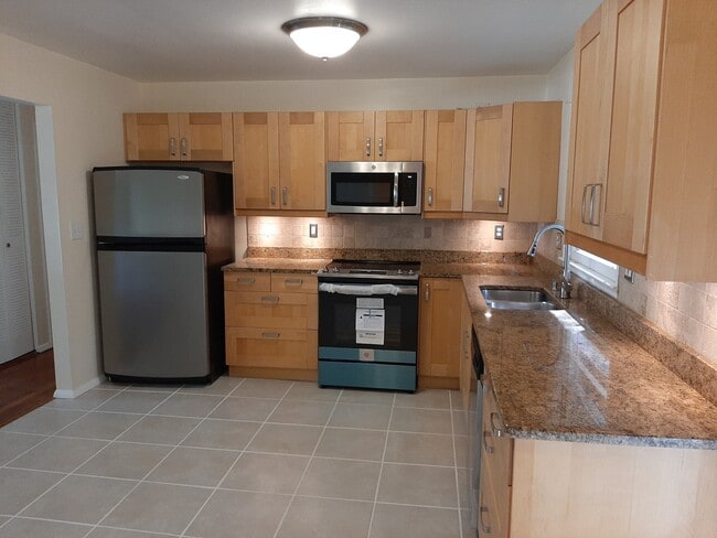 The updated kitchen boasts granite countertops, wooden cabinets, pull-down faucet, and stainless steel appliances. - 2955 Fantasy Ln