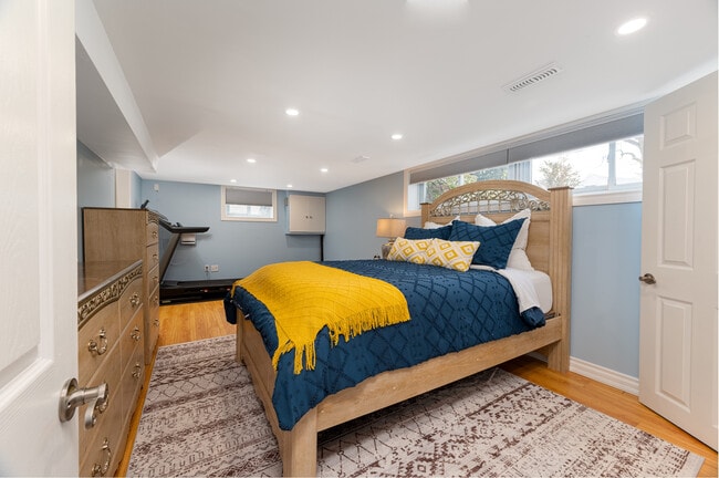 Enjoy restful sleep with blackout blinds that keep the room dark and cozy. - 1191 Pharmacy Av Unit Basement