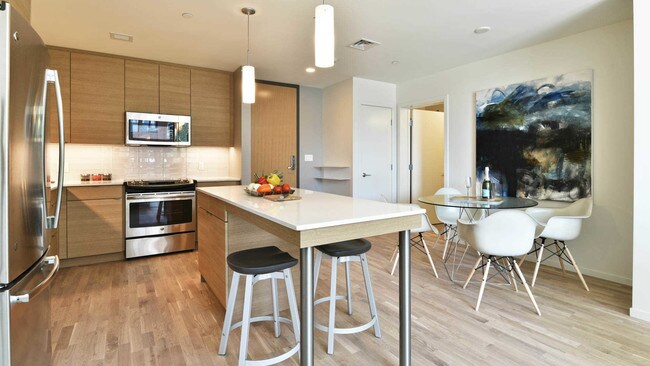 Kitchen with Glass Tile Backsplash and Stainless Steel Appliances