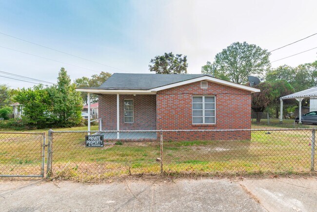 Photo - Brick home with a fenced-in yard! Section ...