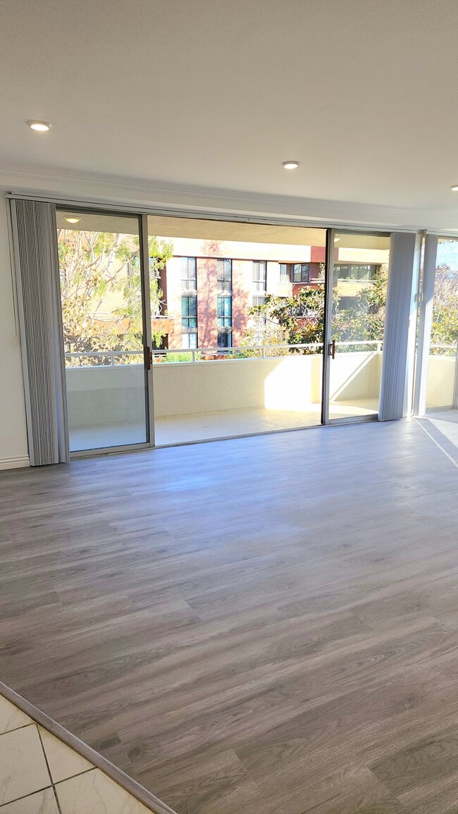 Living Room with Balcony - 303 N Swall Dr Unit 301