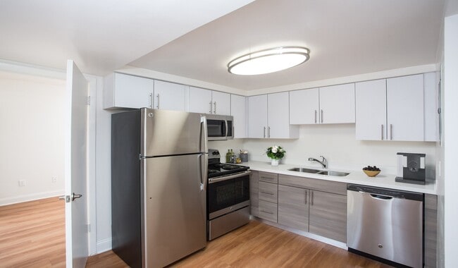 Renovated kitchen with quartz countertops and stainless steel appliances