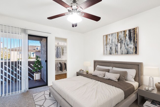 Primary bedroom with patio access - Woodglen Apartments