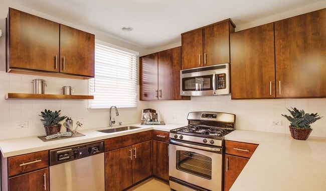 Renovated kitchens with stainless steel appliances, quartz countertops, and walnut cabinets