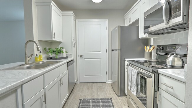 Discover designer kitchen elegance with ample storage in our updated kitchens. - The Grays at Old Town Apartments