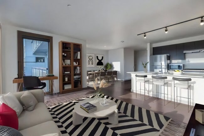 A desk by the window and a bookcase fit in without crowding the seating.