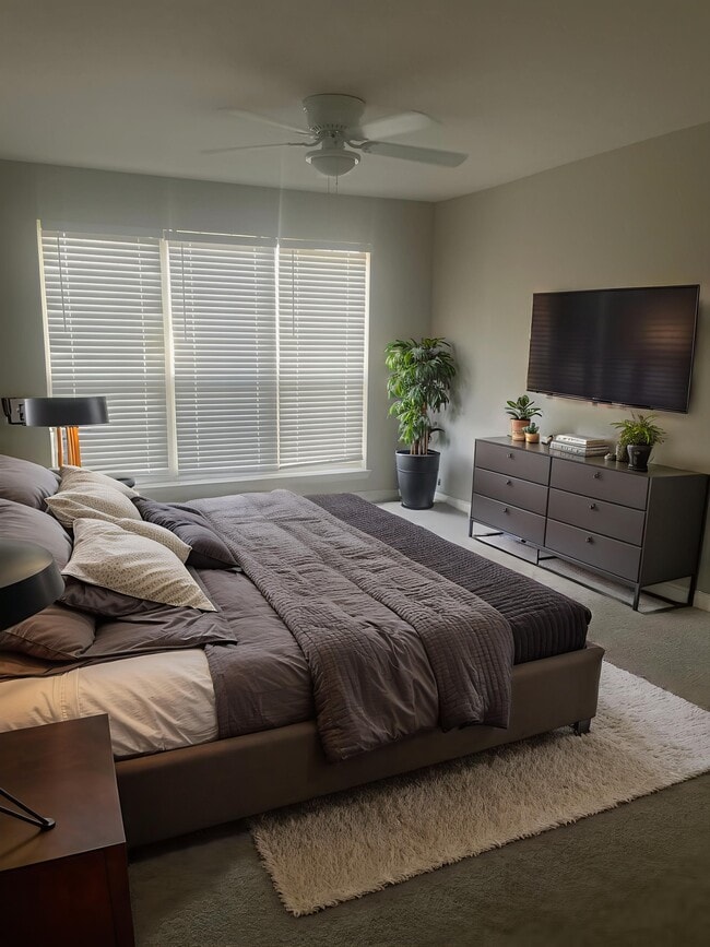 Transform your lifestyle at Riverwood Park Apartments. This spacious bedroom blends comfort and style, featuring modern decor, ample natural light, and a soothing atmosphere. Elevate your everyday living—schedule a tour today!