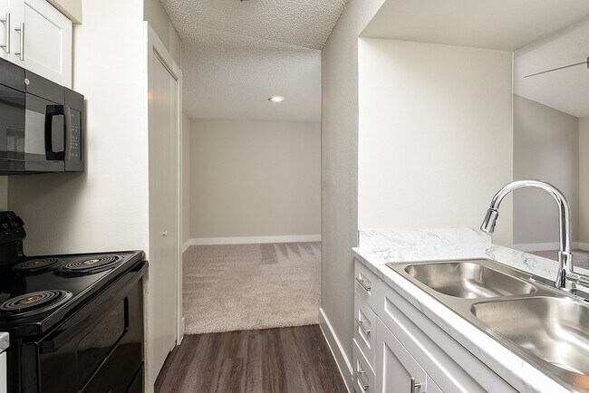 One Bedroom A3 - White Shaker Kitchen Cabinets with Black Appliances