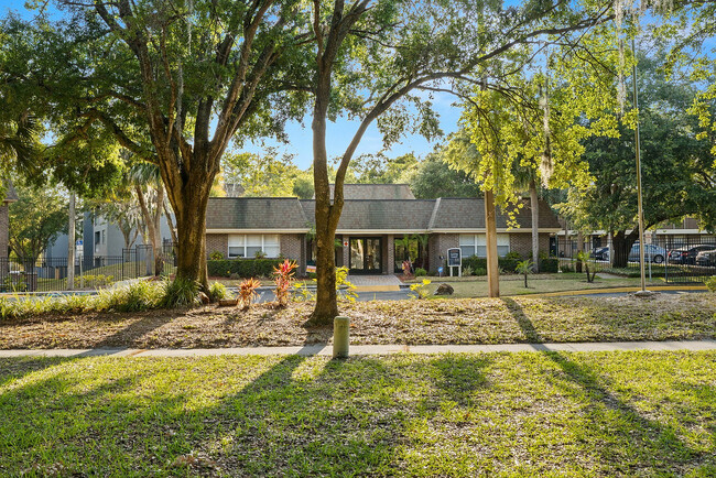 Step into serenity at this charming apartment community, nestled within vibrant greenery. - Doral Oaks Apartments