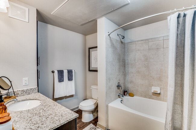 large bathroom with garden tub and granite countertops