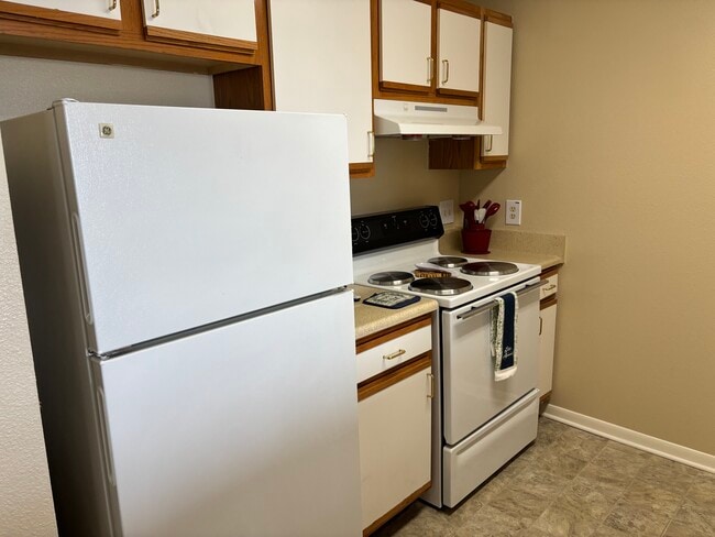 Kitchen, electric range and refrigerator.