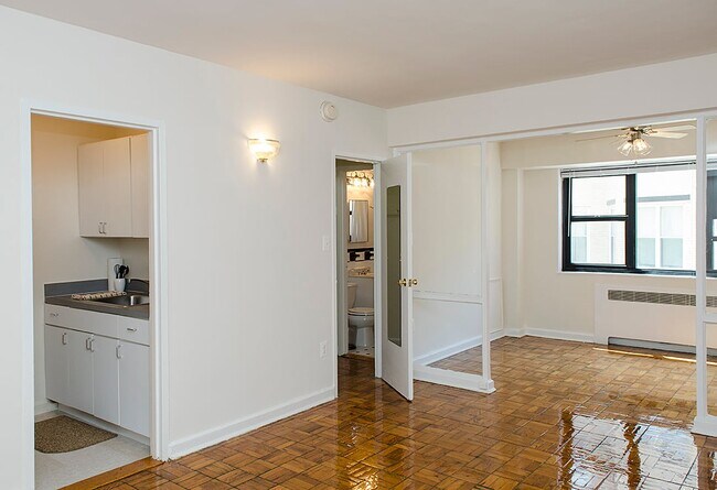 One-bedroom apartment living area with den - The Diplomat