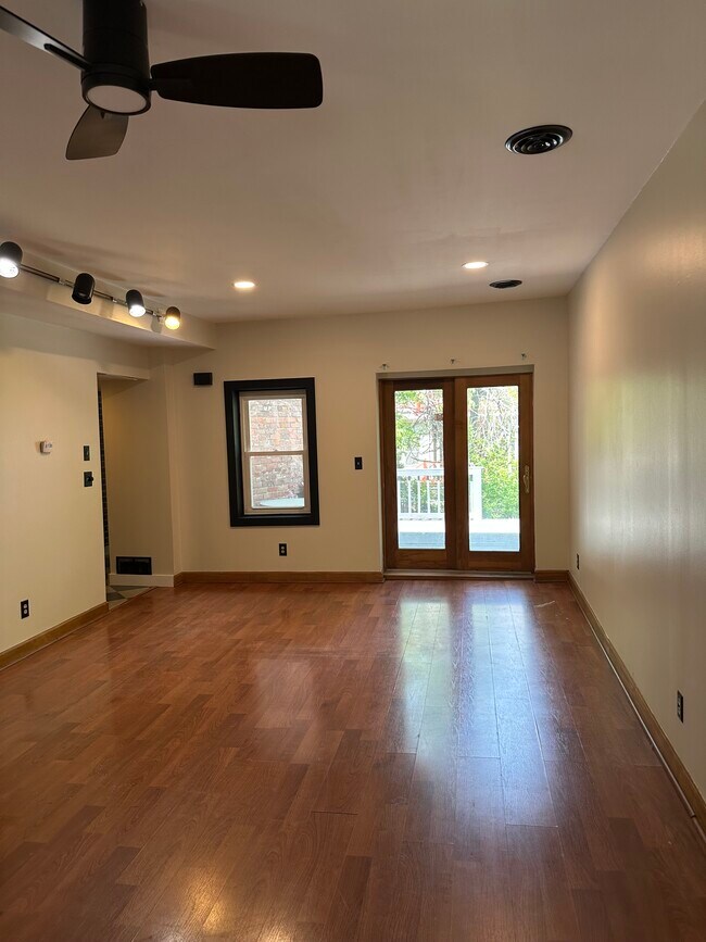 Huge entry living space with door to back yard and windows on both sides of the room. Sunny & open! - 327 Hudson Ave Unit Apartment #1