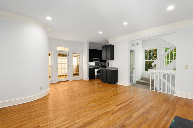 Open living space with hardwood floors and private covered balcony - 197 5th St NE
