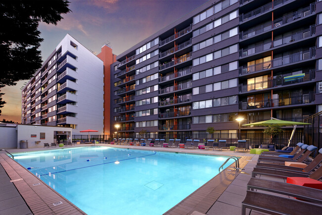 Swimming pool and sundeck with lounge seating - AVA Van Ness Apartments