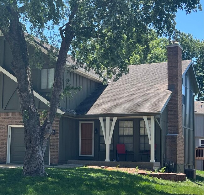 Front door/garage (tree has been removed) - 14103 W 88th Terrace Townhome