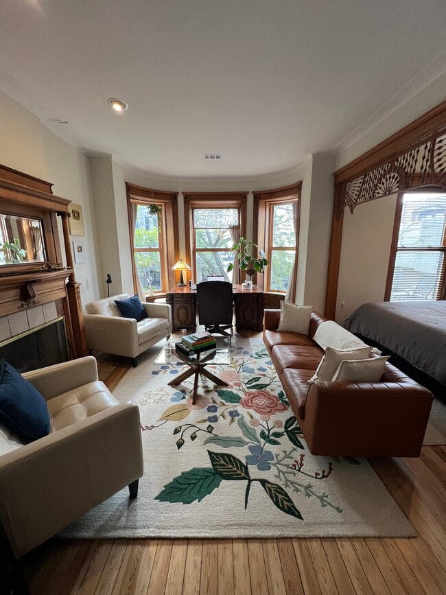 Spacious front living room with leather furniture - 938 W Newport Ave