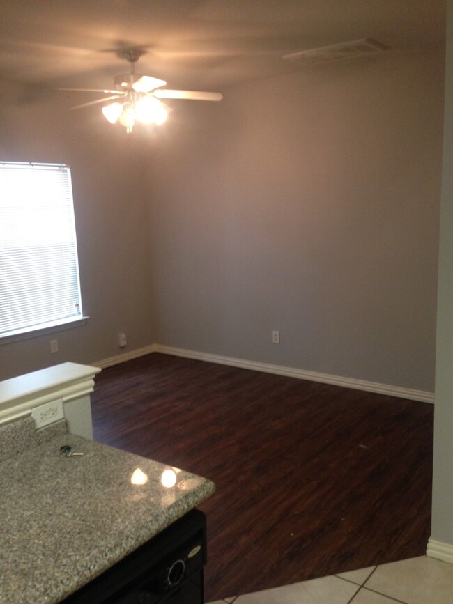 Living room next to kitchen - 7626 Anson Cir Townhome