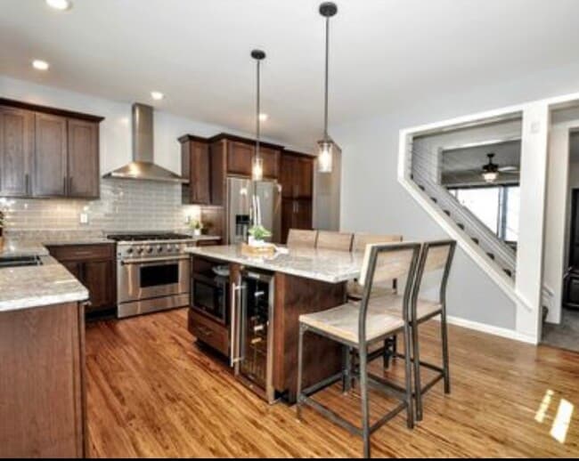 Updated kitchen with stainless steel appliances and island seating