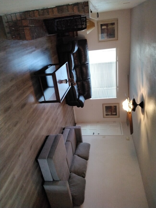 Furnished living room area with fireplace - 3253 W Country Gables Dr Casa