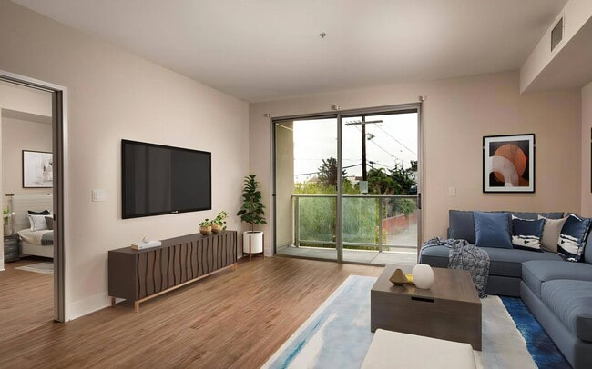 The bedroom opens right off the living space, with the balcony opposite.