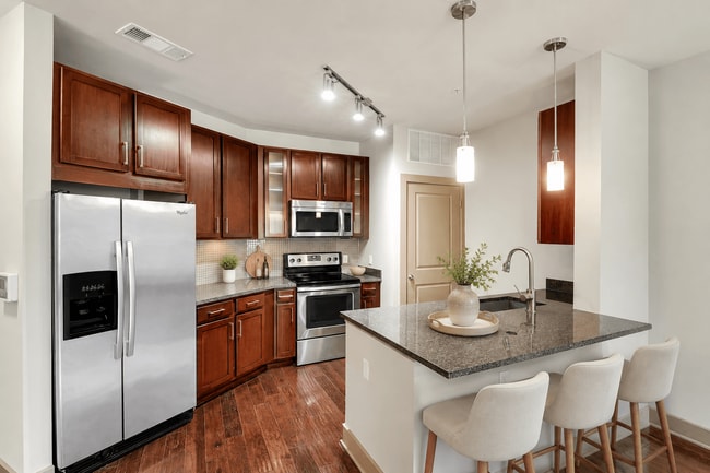 A kitchen with a refrigerator, stove, and oven. - ICON at Dulles