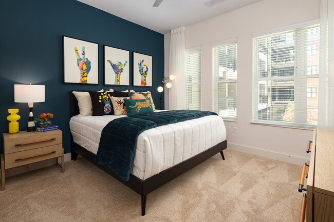 Two windows on the corner keep the bedroom light without losing wall space.