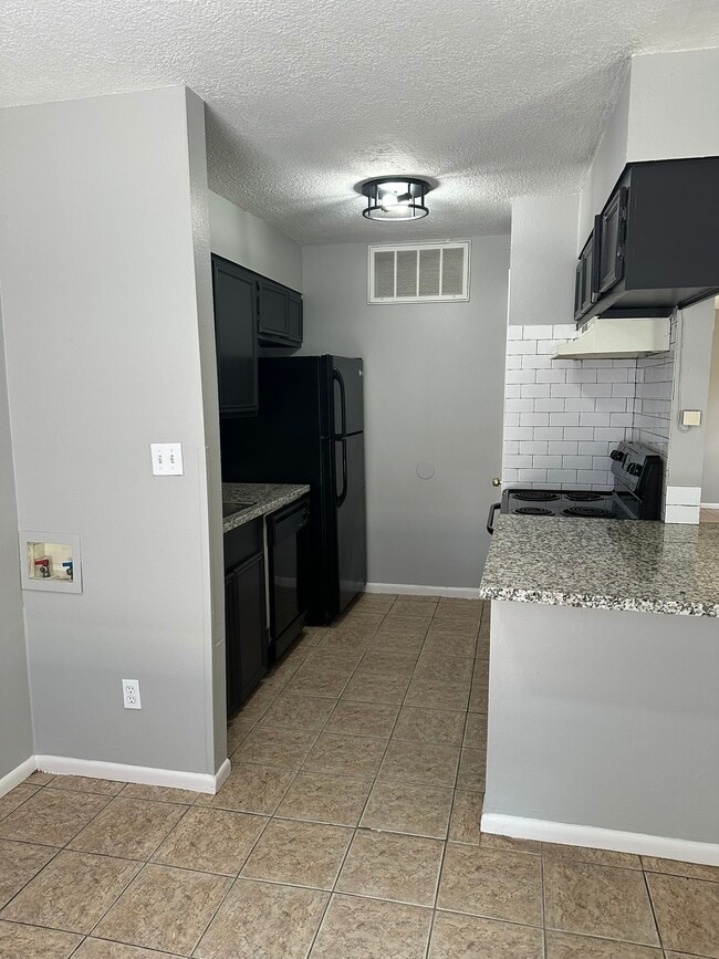 Laundry hook up, Black appliances, subway tile, granite countertops, large closet style pantry - 705 Edgar St Unit B