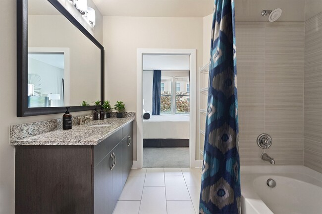 Modern bathrooms with soaking tubs, tile surround and Bluetooth showerheads in select homes