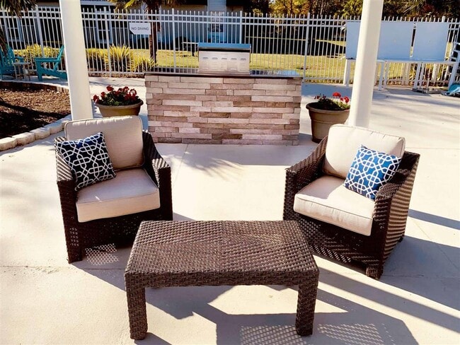 Poolside seating - Coastline Apartments