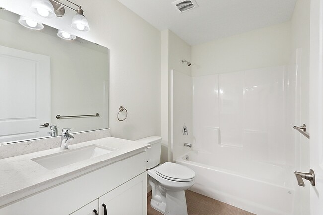 Guest bathroom with tub/shower combo.