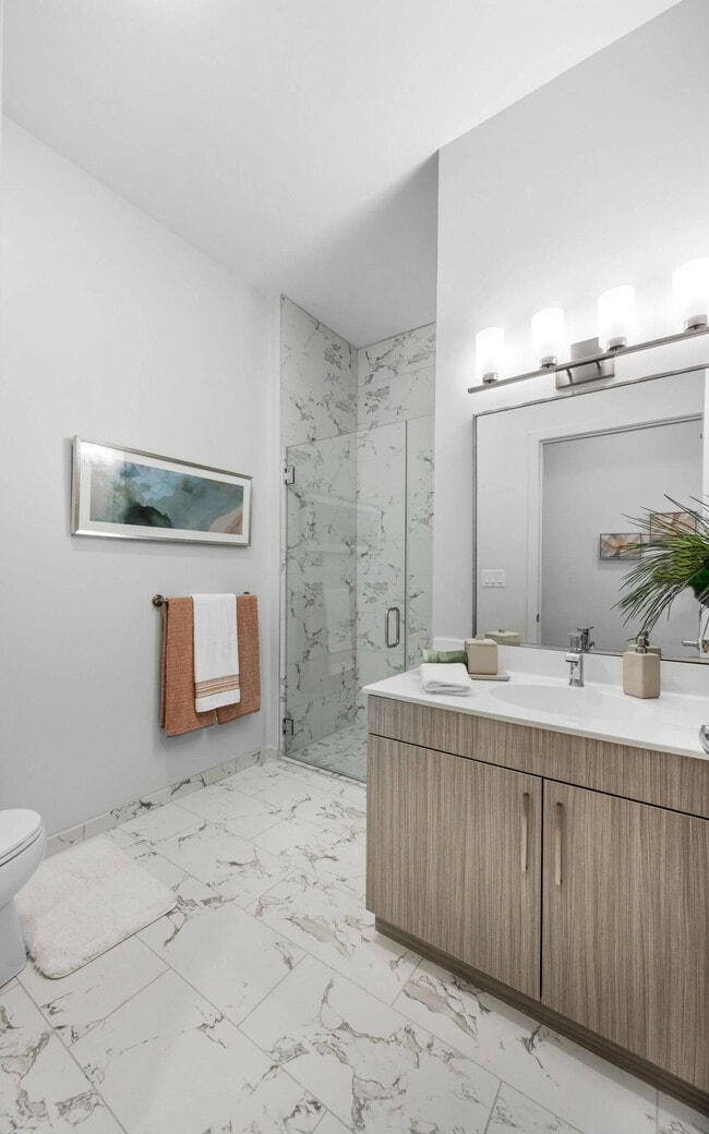 A tiled shower and a tiled floor share one pattern, from top to bottom.