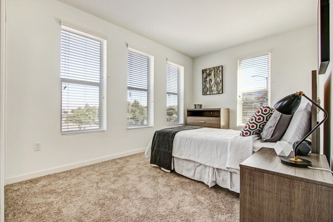 Window treatments include horizontal blinds and roller shades