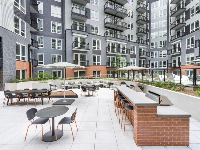 Gather with friends or unwind solo in our expansive courtyard, featuring grilling stations, shaded dining areas, and plenty of space to relax. - Modera H Street