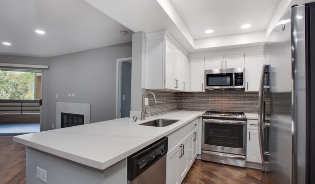 Kitchen complete with quartz countertops and wood flooring