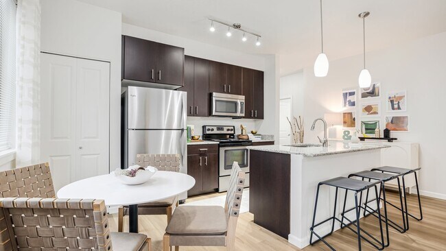 Spacious kitchen islands with seating create stylish spaces for dining and entertaining - Victory Flats at Elmonica Station Apartments