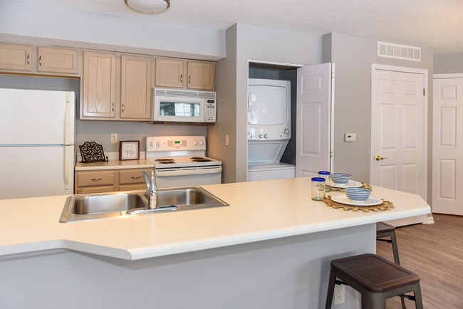 Well-equipped kitchen with breakfast bar & in-unit washer/dryer