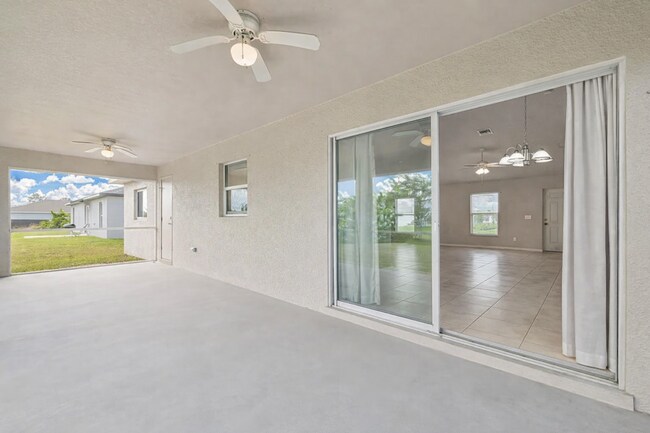 Photo - Spacious Three-Bedroom Home with Open Floor Plan, Large Yard & Screened Patio