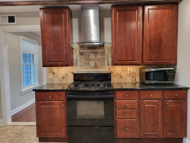 Stove and cabinetry - 731 N Stokes St Unit Apt. A