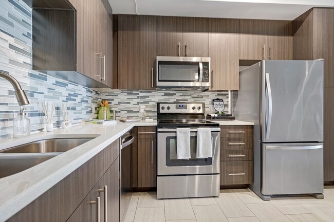 Kitchen and kitchen island within open concept apartment in Boca Raton.