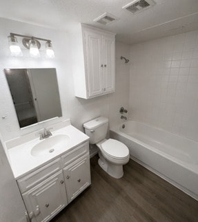 Updated bathroom with sleek white cabinetry and ample storage