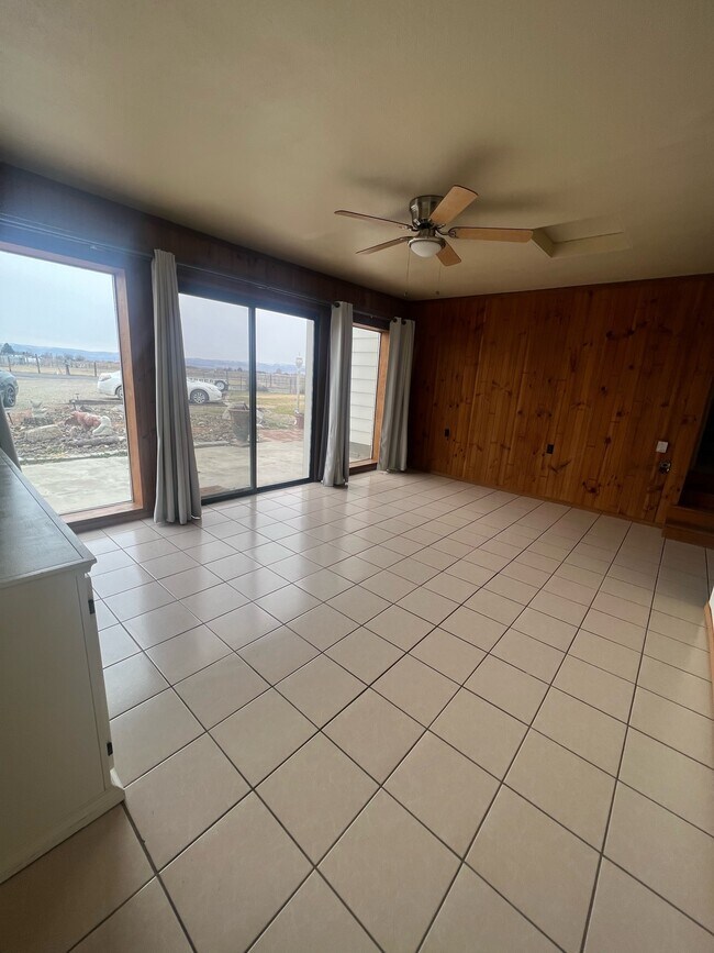 Living room has sliding door for easy access to front porch area. - 881 Bishop Rd Unit A