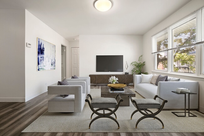 Bright, modern living room with elegant furniture, large windows, and contemporary decor, creating a welcoming atmosphere.