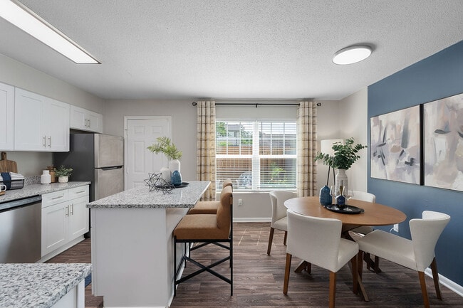 Kitchen and dining area with hardwood-style flooring
