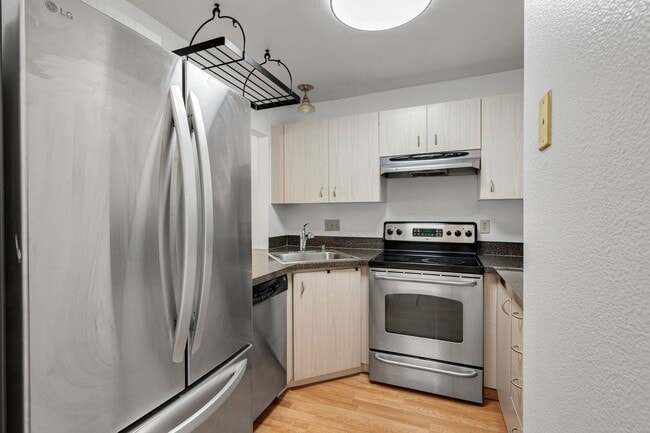 Photo - 2 level condo, 3 decks, Stainless Appliances, 2 parking spots, Water, sewer, garbage included!