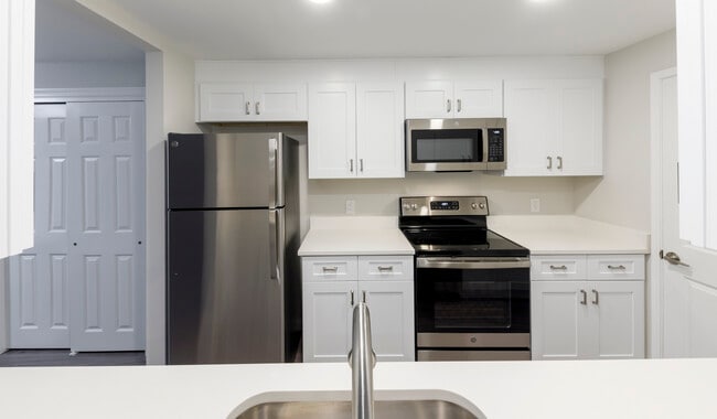 New homes feature upgraded finishes including quartz countertops, stainless steel appliances and soft-close cabinetry - Royal Crest Estates North Andover Apartments