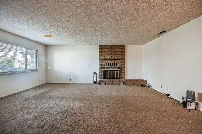 Photo - 3 bedroom, 2 bath with large living room and brick fireplace.  Good size kitchen with tons of cab...