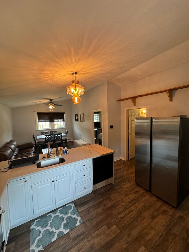 Full picture of main area with dishwasher and refrigerator.