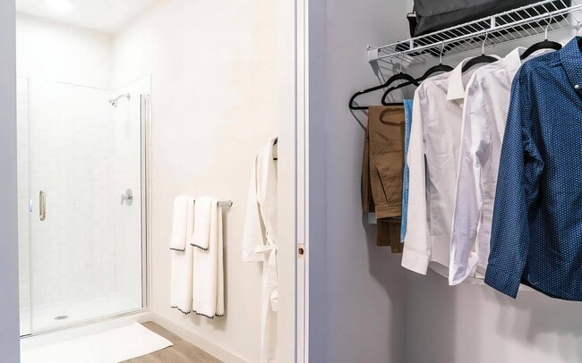 Walk-In Closet with Built-In Shelving Adjacent to Spacious Bathroom - The Madison at Marshfield